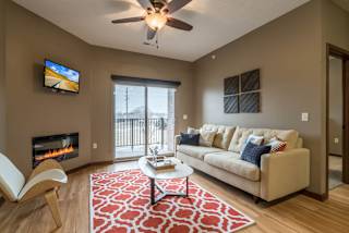 A living room with a fireplace, a couch, and a television.