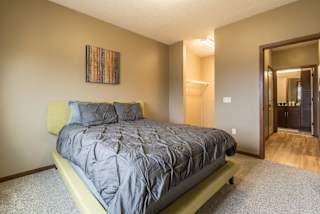 A bedroom with a bed and a walk-in closet