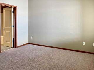 A bedroom with an attached bathroom and walk-in closet.