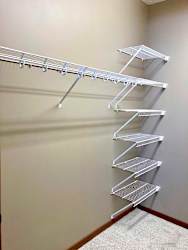 A walk-in closet with wire shelving and hanging space.