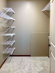 A spacious walk-in closet in the primary bedroom with built-in shelves.