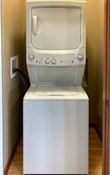A stacked washer and dryer in a laundry closet.