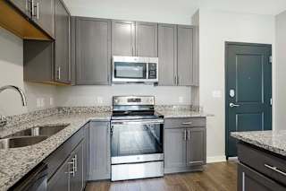a kitchen with stainless steel appliances and granite counter tops