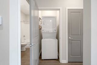 a stackable washer and dryer in a closet