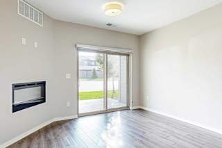 a living room with a fireplace and a sliding glass door