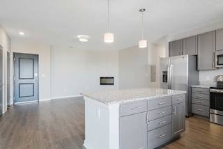 an open kitchen and living room with a large island