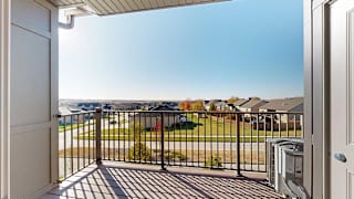 a balcony with a view of neighboring houses