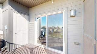 a balcony with outdoor storage and a sliding glass door