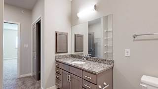 a bathroom with a large vanity sink with granite countertop and a medicine cabinet