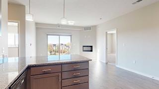 an open-concept living room and kitchen with peninsula countertop