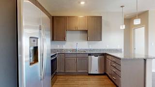 a kitchen with stainless steel appliances and grey wooden cabinets