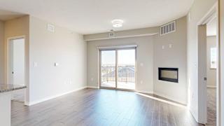 a living room with a large sliding glass door, a fireplace, and luxury vinyl hardwood flooring
