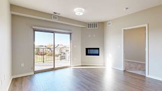 a bright living room with a large sliding glass door and a fireplace
