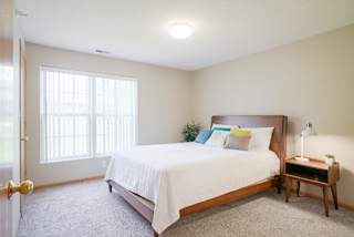 A furnished bedroom with a large bed and a window at Williamsburg Park