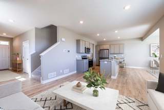 A modern living room with a staircase leading to the upper floor.