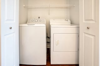 an empty laundry room with two washes and a dryer at Barton Farms in Greenwood, IN 46143