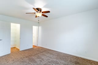 a living room with a ceiling fan and a carpet at Barton Farms in Greenwood, IN 46143