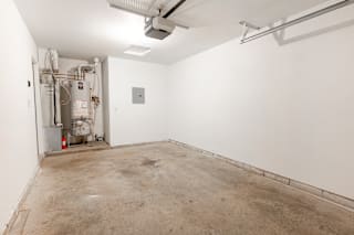 an empty room with a cement floor and white walls at Barton Farms in Greenwood, IN 46143