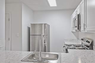 a kitchen with a sink and a refrigerator