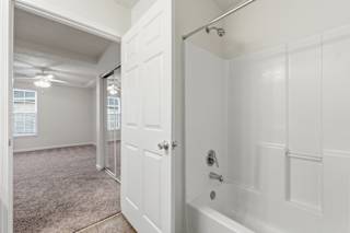A white bathroom with a tub and a shower.