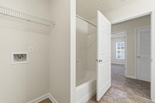 A white door is open to a hallway.