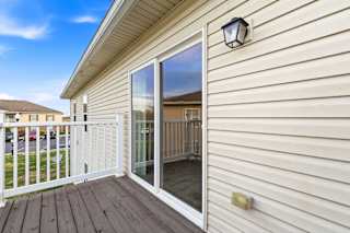 A house with a deck and a sliding glass door.