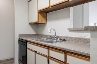 Well-equipped model unit kitchen featuring black appliances and a clean layout.