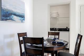 A dining area in a model unit at Skyler Ridge Complex, offering an open space for meals and gatherings.