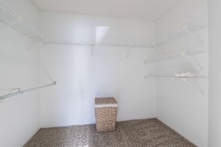 Clean, empty model unit closet at Skyler Ridge with white walls and a hanging rail.