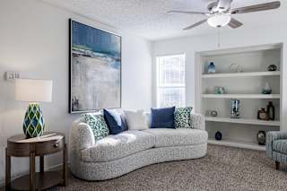 A spacious and versatile living room in a model unit at Skyler Ridge Complex.