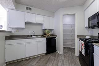 Well-equipped kitchen in a Skyler Ridge model unit with black appliances and a functional layout.