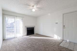 A well-lit living room in a model unit at Skyler Ridge Complex, offering comfort and flexibility.