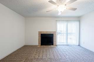 A well-lit living room in a model unit at Skyler Ridge Complex, offering comfort and flexibility.