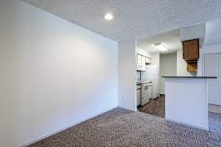Model unit kitchen and dining area at Skyler Ridge with black appliances and open flow.