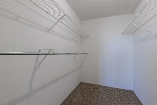 Clean, empty model unit closet at Skyler Ridge with white walls and a hanging rail.