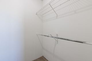 Clean, empty model unit closet at Skyler Ridge with white walls and a hanging rail.