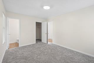 A room with carpeted floor and white walls.