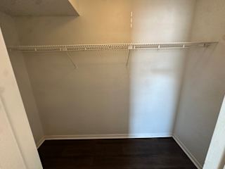 Empty room with a white shelf and dark wood floor.at Auburn Glen Apartments, Jacksonville