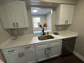 A kitchen with white cabinets and a sink.at Auburn Glen Apartments, Jacksonville