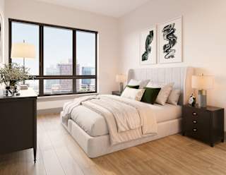 a bedroom with a large window and a bed with blankets and pillows at Bemiston Place Apartments, Clayton