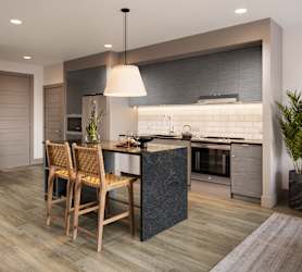 a kitchen with an island and a table with chairs at Bemiston Place Apartments, Clayton, MO 63105