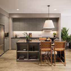 a kitchen with a large island with a table and chairs at Bemiston Place Apartments, Clayton, 63105