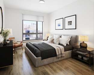 a bedroom with a large bed and a large window at Bemiston Place Apartments, Clayton, MO