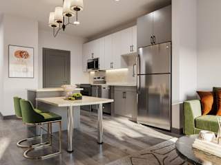 a kitchen and dining room with stainless steel appliances and a table and chairs at The Porter, Maryland Heights Missouri