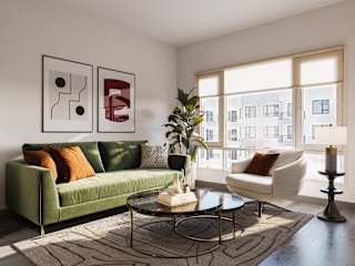 a living room with a green couch and a large window at The Porter, Maryland Heights, MO