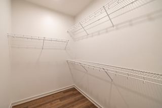Empty walk-in closet with shelves and wooden floor at Timber Club, St. Peters
