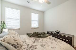 Bedroom with a cozy bed at Timber Club, St. Peters, MO