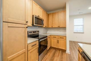 Modern Kitchen with Wooden Cabinetry at Timber Club, St. Peters, MO
