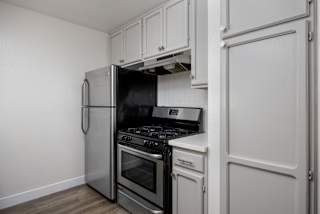 a kitchen with stainless steel appliances and white cabinets