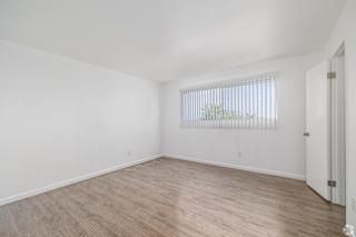 A room with a window and a door.
